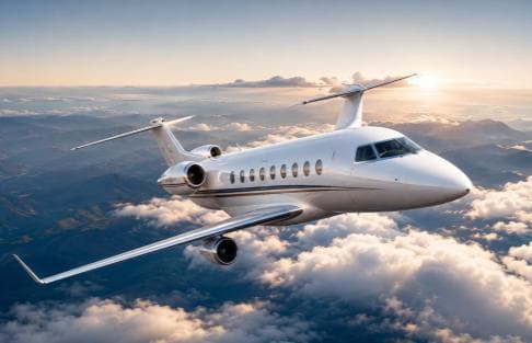 Business jet in flight at sunset